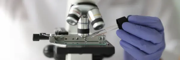 Scientist working with pipette microscope laboratory science technology research